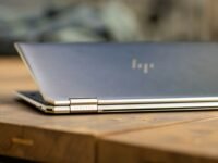 silver macbook on brown wooden table